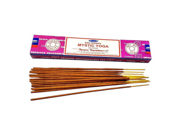 Incense sticks with their packaging labeled 'Mystic Yoga' on a white background